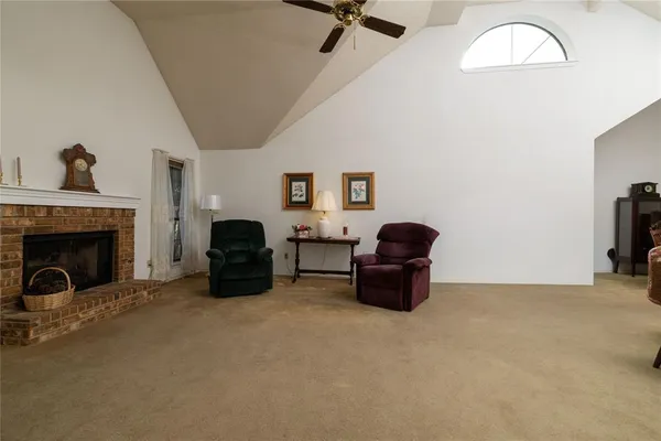 a living room with furniture a fireplace and a chandelier