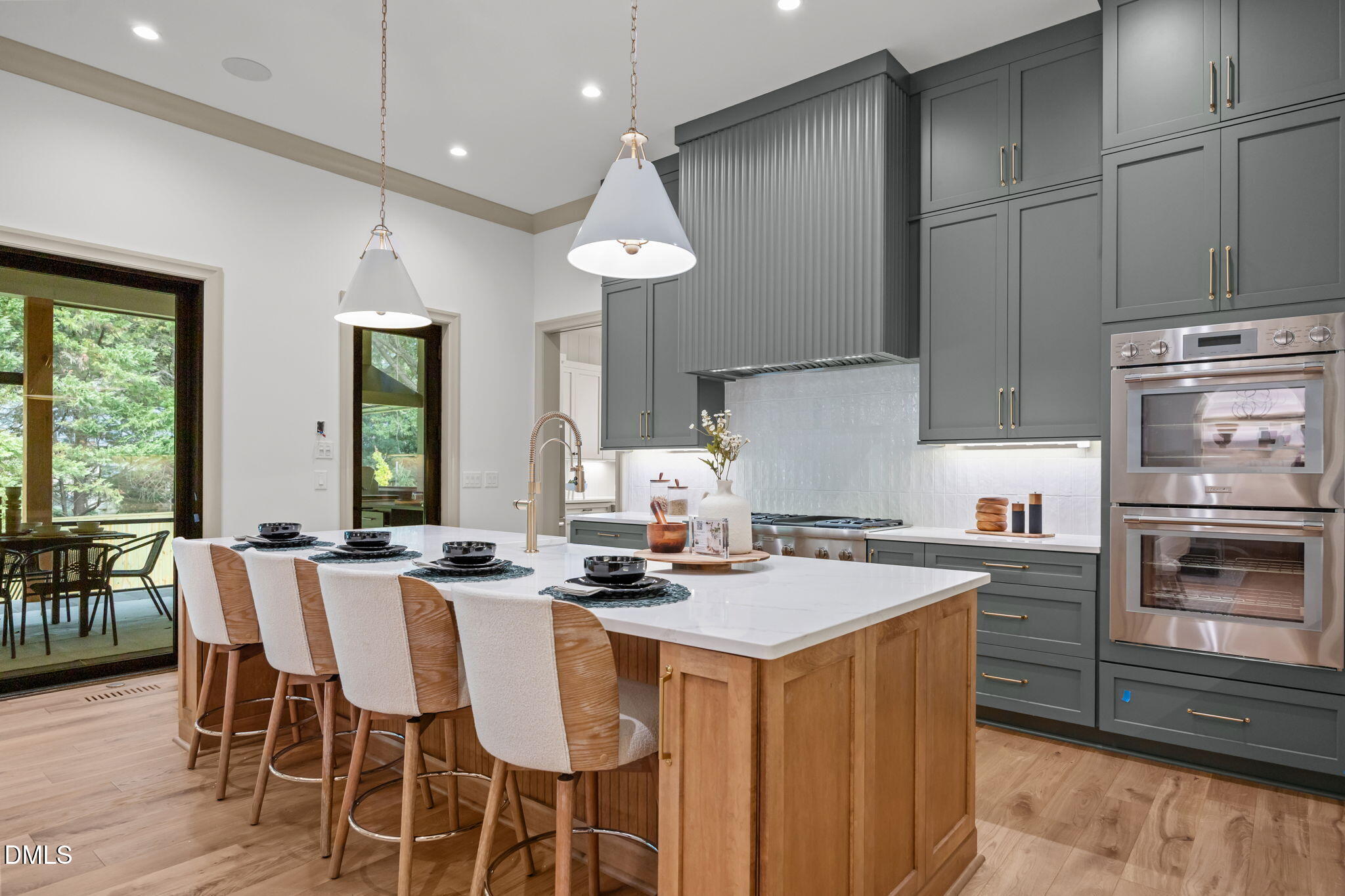 1116 Kimberly Drive Raleigh, NC 27609 - Photo 13 of 71 a kitchen with stainless steel appliances a stove a sink island and chairs