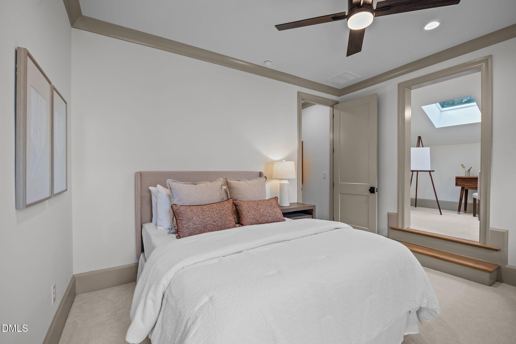 1116 Kimberly Drive Raleigh, NC 27609 - Photo 59 of 71 a bedroom with a bed and a chandelier