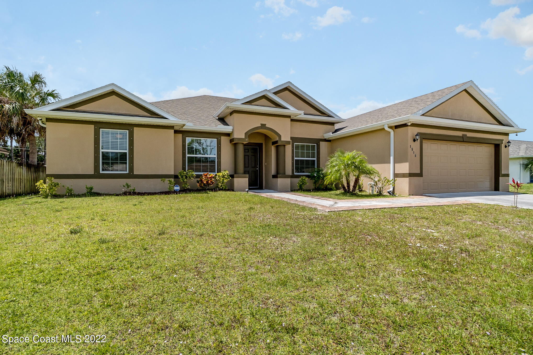 1516 Adview Road Southeast Palm Bay, FL 32909 - Photo 1 of 22 a front view of a house with yard and garage