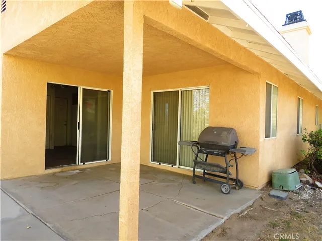 a view of a livingroom with chairs and couch