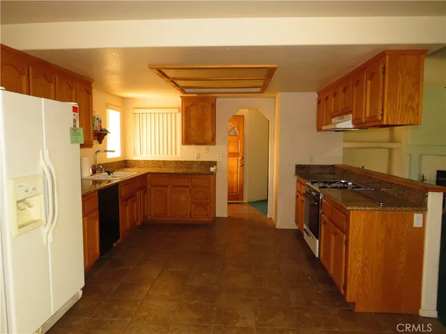 a kitchen with a refrigerator and a sink