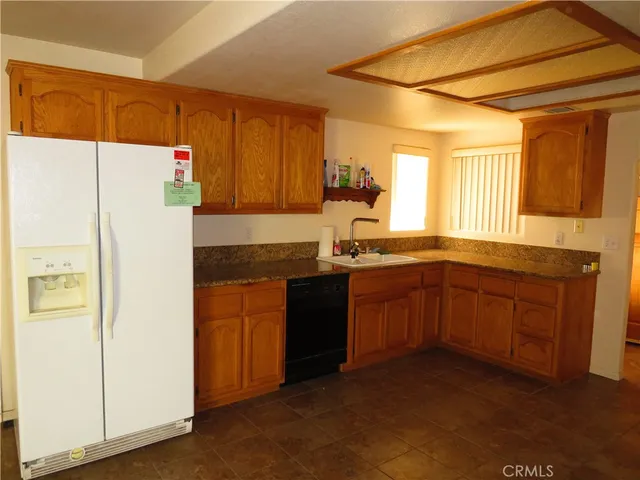 a kitchen with a refrigerator and a sink