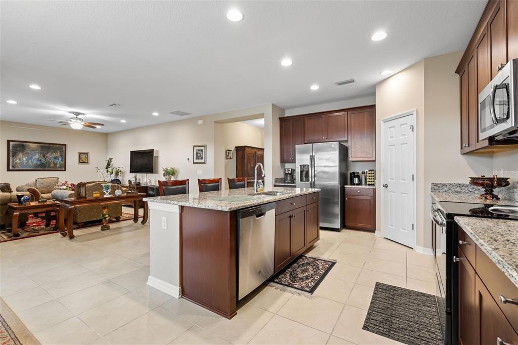 31046 Parrot Reef Court Wesley Chapel, FL 33545 - Photo 18 of 99 a large kitchen with stainless steel appliances lots of counter top space
