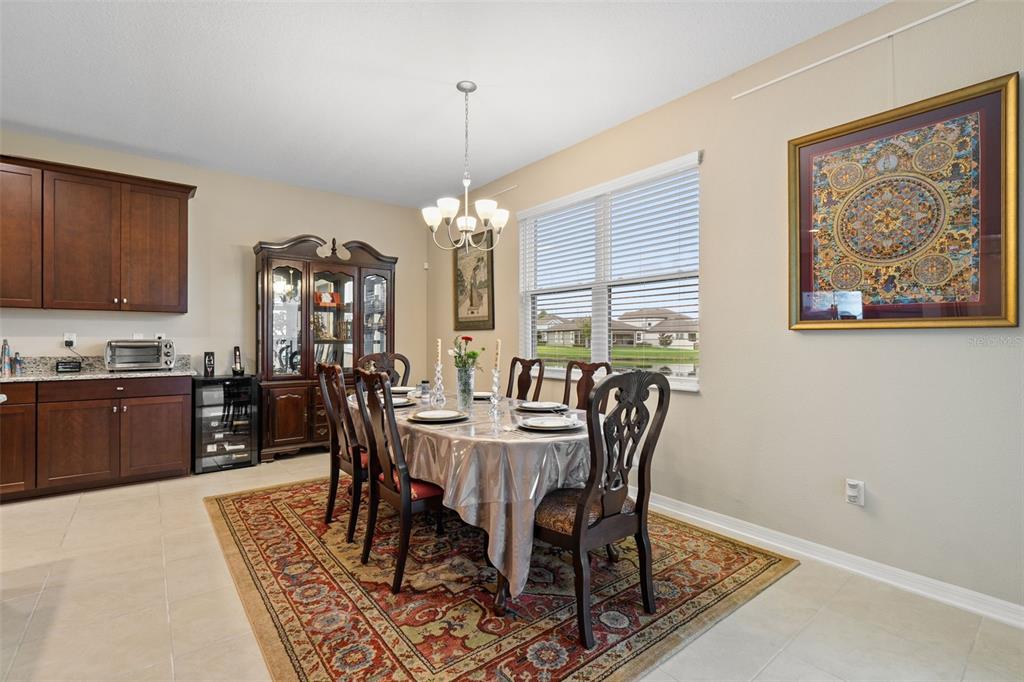 31046 Parrot Reef Court Wesley Chapel, FL 33545 - Photo 22 of 99 a view of a dining room with furniture window and wooden floor