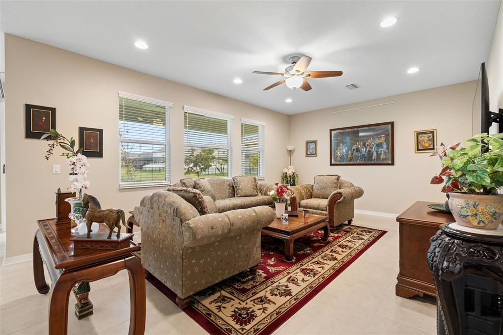 31046 Parrot Reef Court Wesley Chapel, FL 33545 - Photo 25 of 99 a living room with furniture and a large window