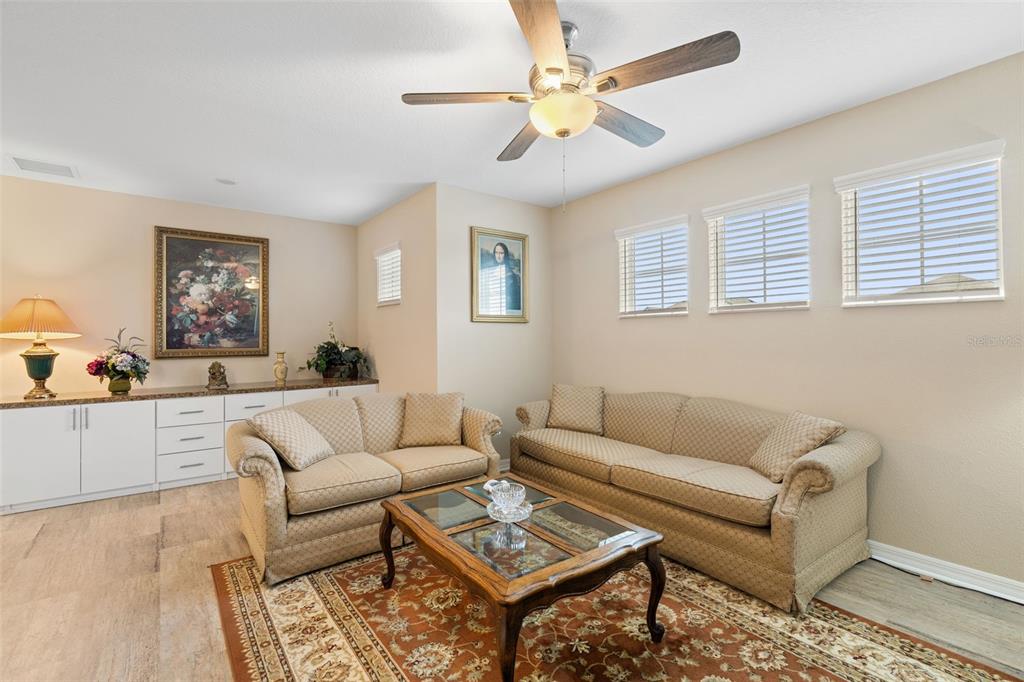 31046 Parrot Reef Court Wesley Chapel, FL 33545 - Photo 31 of 99 a living room with furniture a view of bedroom and a window