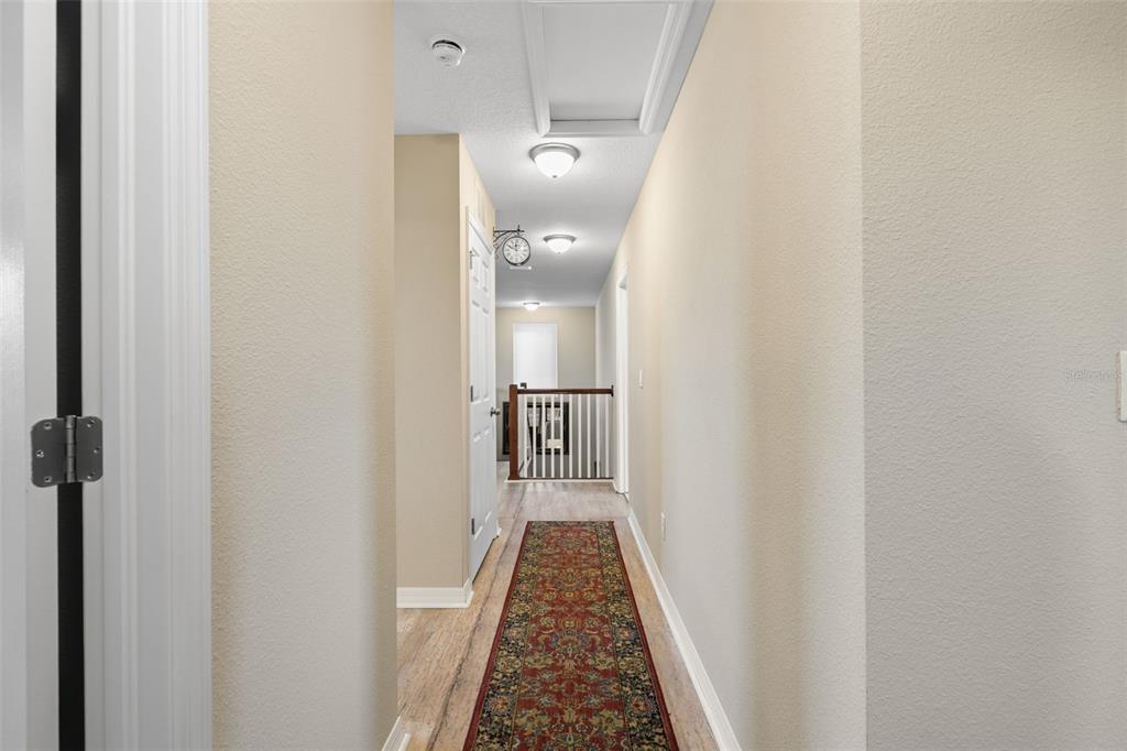 31046 Parrot Reef Court Wesley Chapel, FL 33545 - Photo 43 of 99 a view of hallway with wooden floor