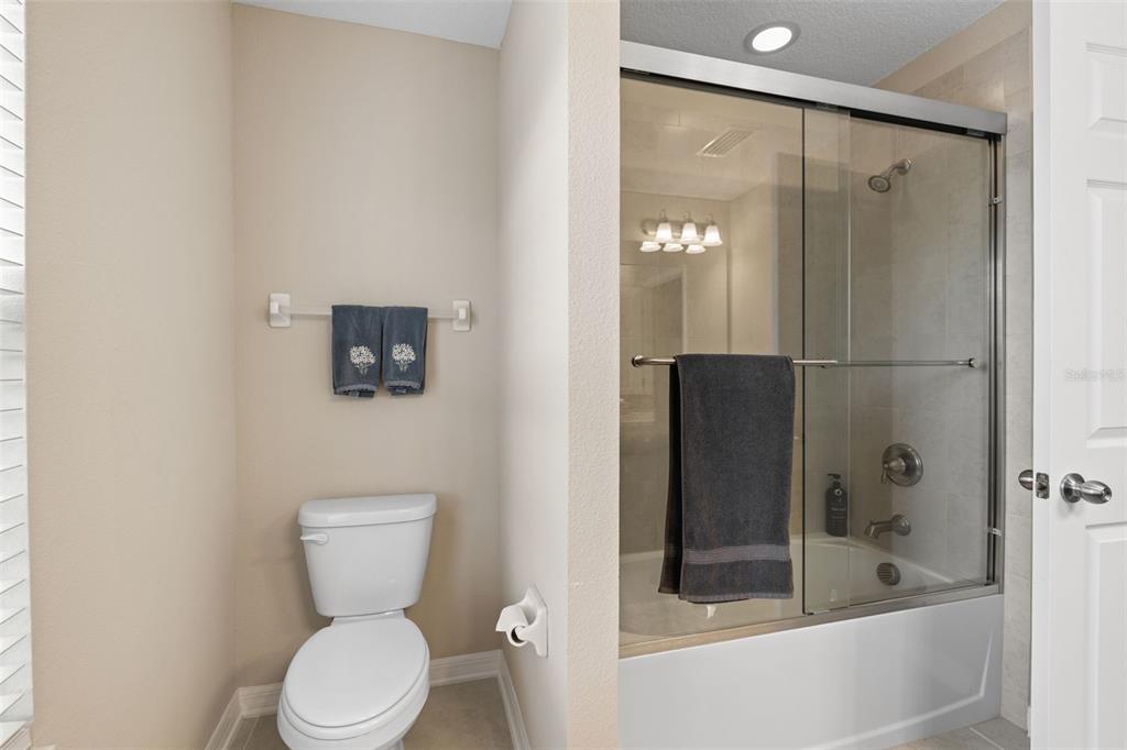 31046 Parrot Reef Court Wesley Chapel, FL 33545 - Photo 48 of 99 a bathroom with a toilet and a shower