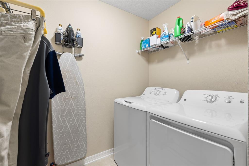 31046 Parrot Reef Court Wesley Chapel, FL 33545 - Photo 51 of 99 a utility room with dryer and washer