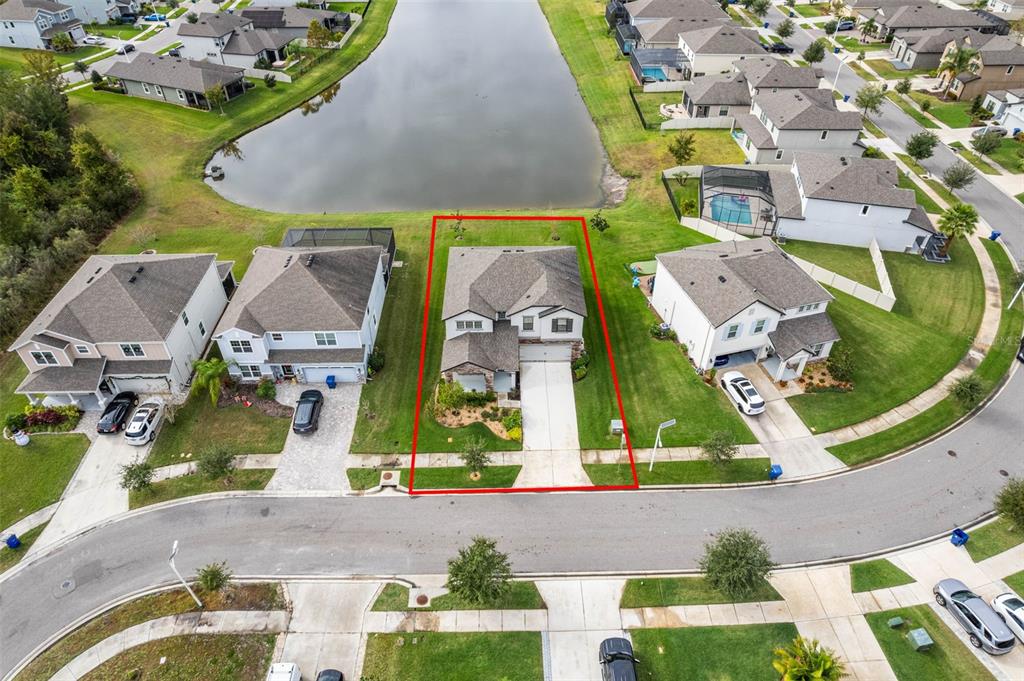 31046 Parrot Reef Court Wesley Chapel, FL 33545 - Photo 60 of 99 an aerial view of residential houses with outdoor space and parking