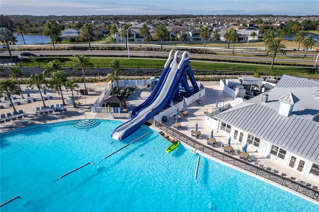 31046 Parrot Reef Court Wesley Chapel, FL 33545 - Photo 78 of 99 a view of a swimming pool with a patio and a lake view