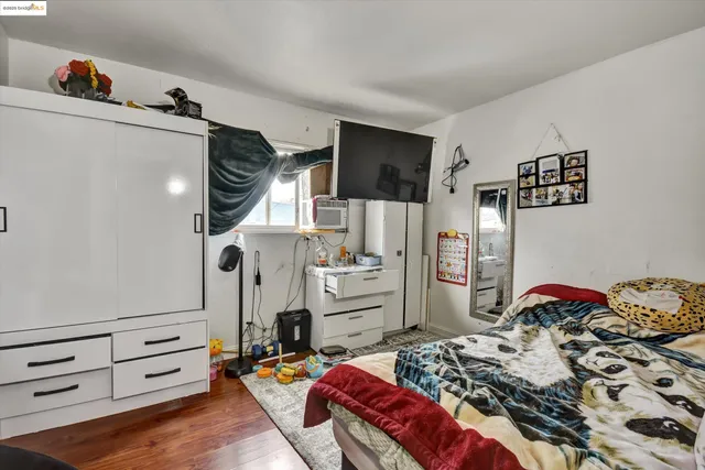 a bedroom with furniture and a wooden floor