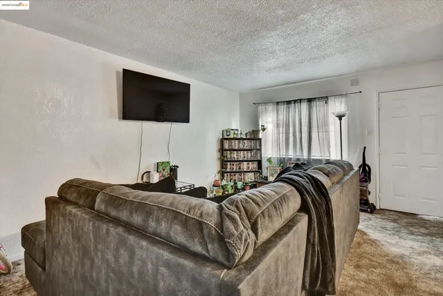 a bed room with a bed a television and a couch