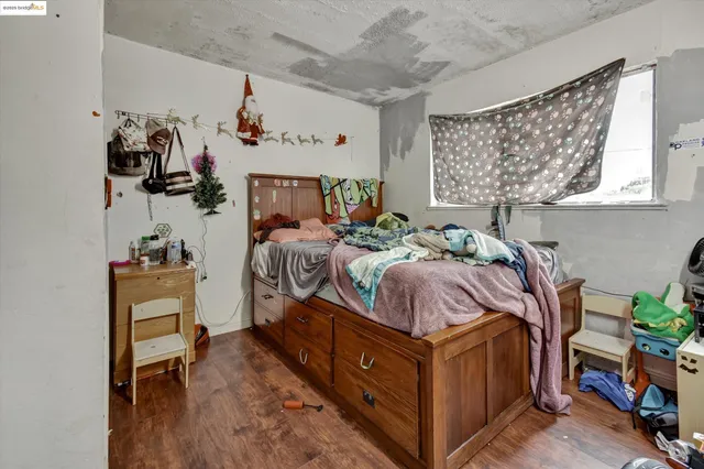 a bed room with a bed and a chair