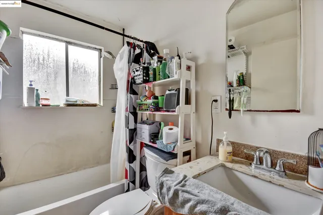 a bedroom with a bed and a mirror