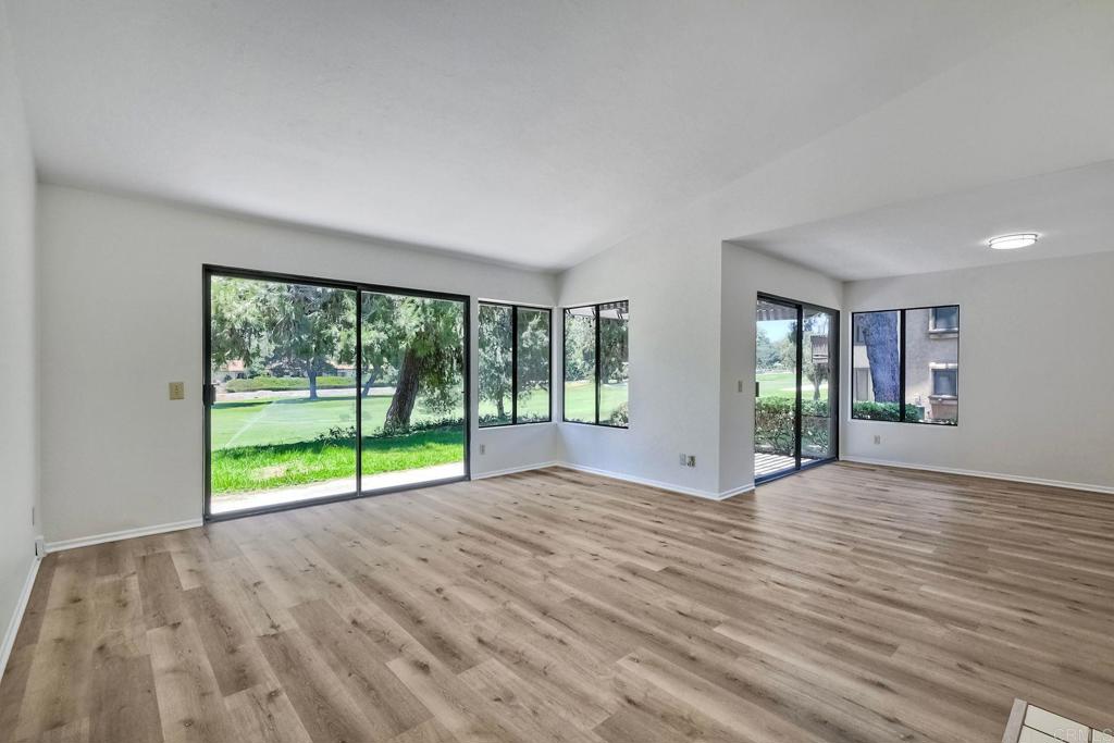 4135 Pinehurst Court Fallbrook, CA 92028 - Photo 8 of 25 a view of an empty room with wooden floor and a floor to ceiling window