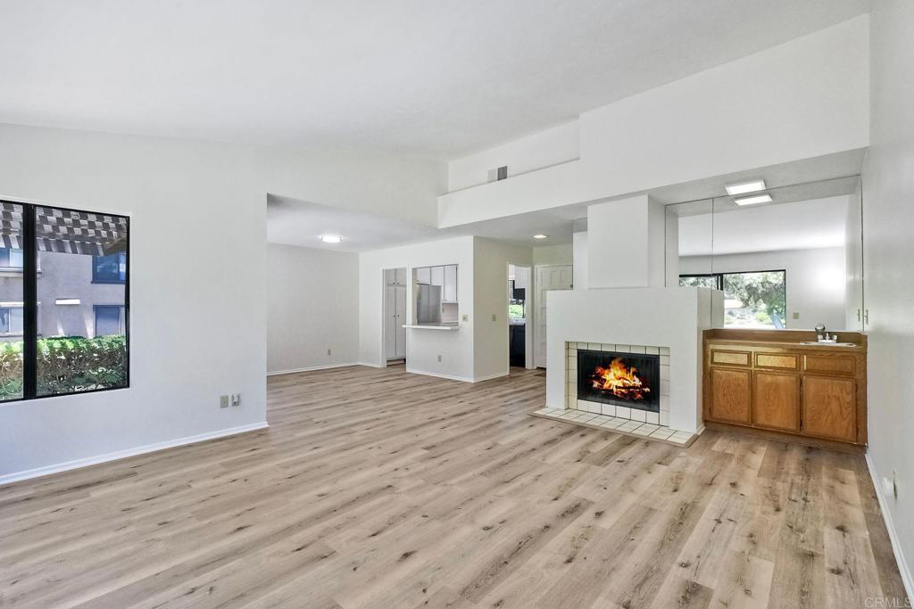 4135 Pinehurst Court Fallbrook, CA 92028 - Photo 9 of 25 a view of an empty room with a fireplace and a window