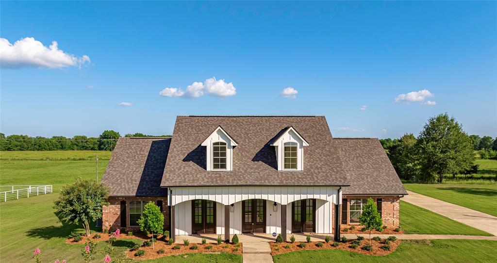 a front view of a house with garden and patio