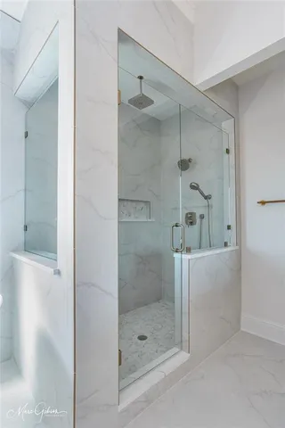 a bathroom with a glass shower door