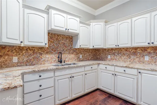 a kitchen with white cabinets and white appliances