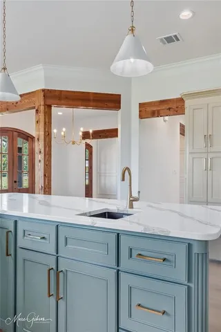 a sink with a granite countertop vanity and a mirror