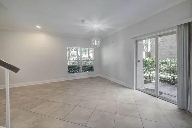 a view of an empty room with glass door