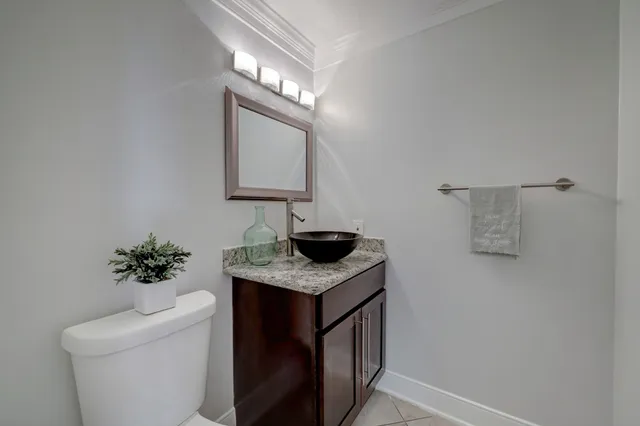 a bathroom with a sink a light fixture and a toilet
