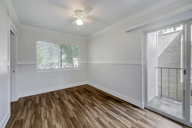 a view of a room with wooden floor and windows