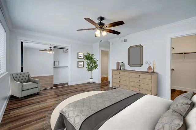 a bedroom with a bed and ceiling fan