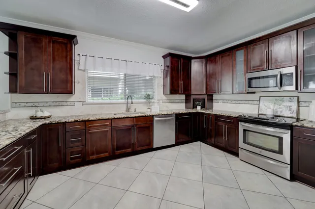 a kitchen with a sink stove and cabinets