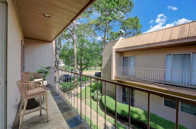 a view of balcony with furniture