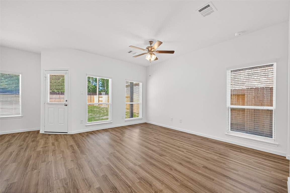 20835 Attalos Stoa Road Crosby, TX 77532 - Photo 11 of 46 a view of an empty room with wooden floor and a window