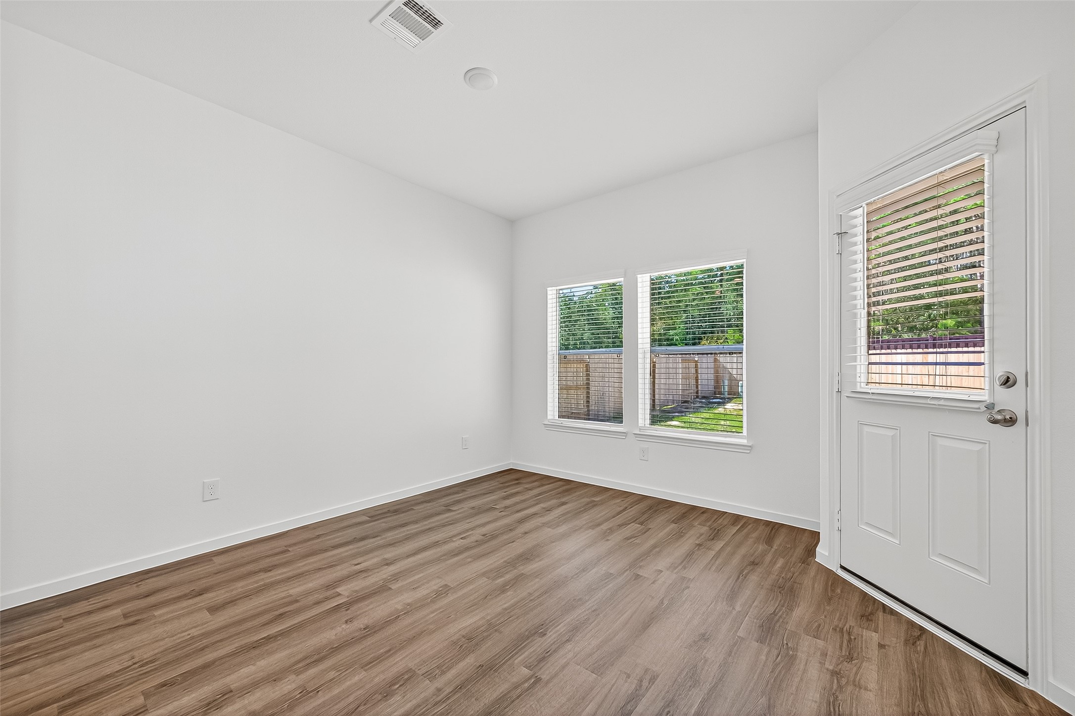 20835 Attalos Stoa Road Crosby, TX 77532 - Photo 12 of 46 wooden floor in an empty room with a window
