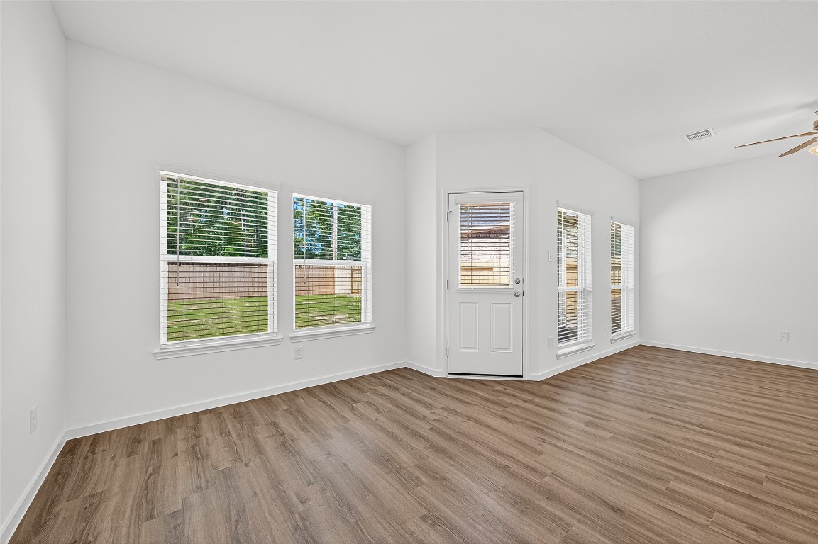 20835 Attalos Stoa Road Crosby, TX 77532 - Photo 13 of 46 a view of an empty room with wooden floor and windows