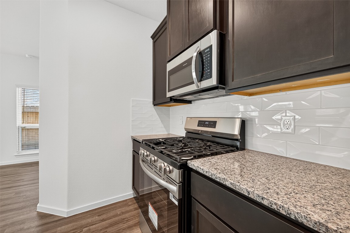 20835 Attalos Stoa Road Crosby, TX 77532 - Photo 19 of 46 a kitchen with stainless steel appliances granite countertop a stove and a microwave