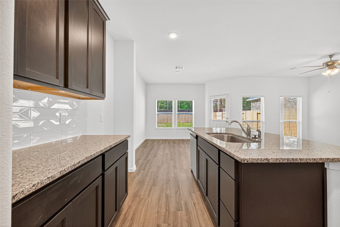 20835 Attalos Stoa Road Crosby, TX 77532 - Photo 20 of 46 a kitchen with granite countertop stainless steel appliances a sink stove and cabinets