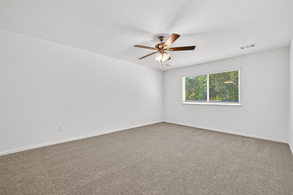 20835 Attalos Stoa Road Crosby, TX 77532 - Photo 30 of 46 an empty room with a window and a ceiling fan