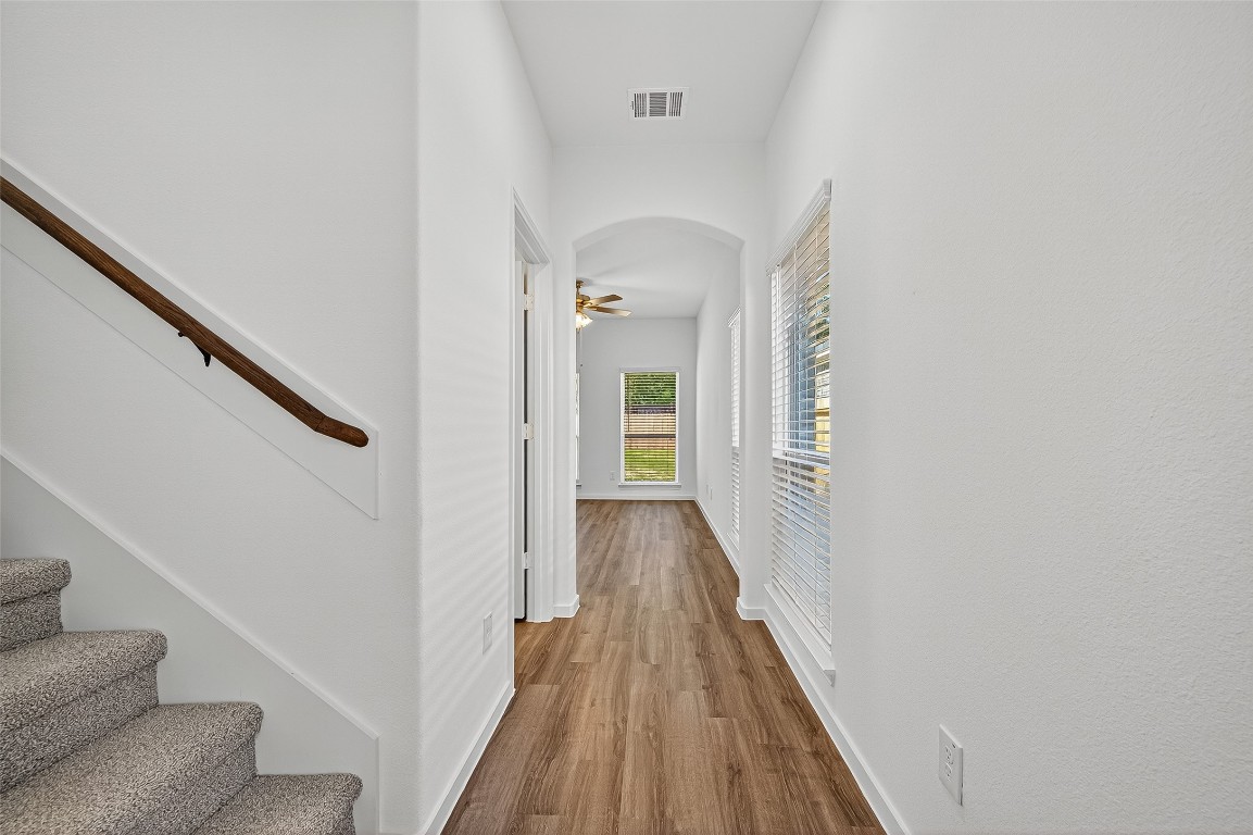 20835 Attalos Stoa Road Crosby, TX 77532 - Photo 7 of 46 a view of a hallway with wooden floor and staircase