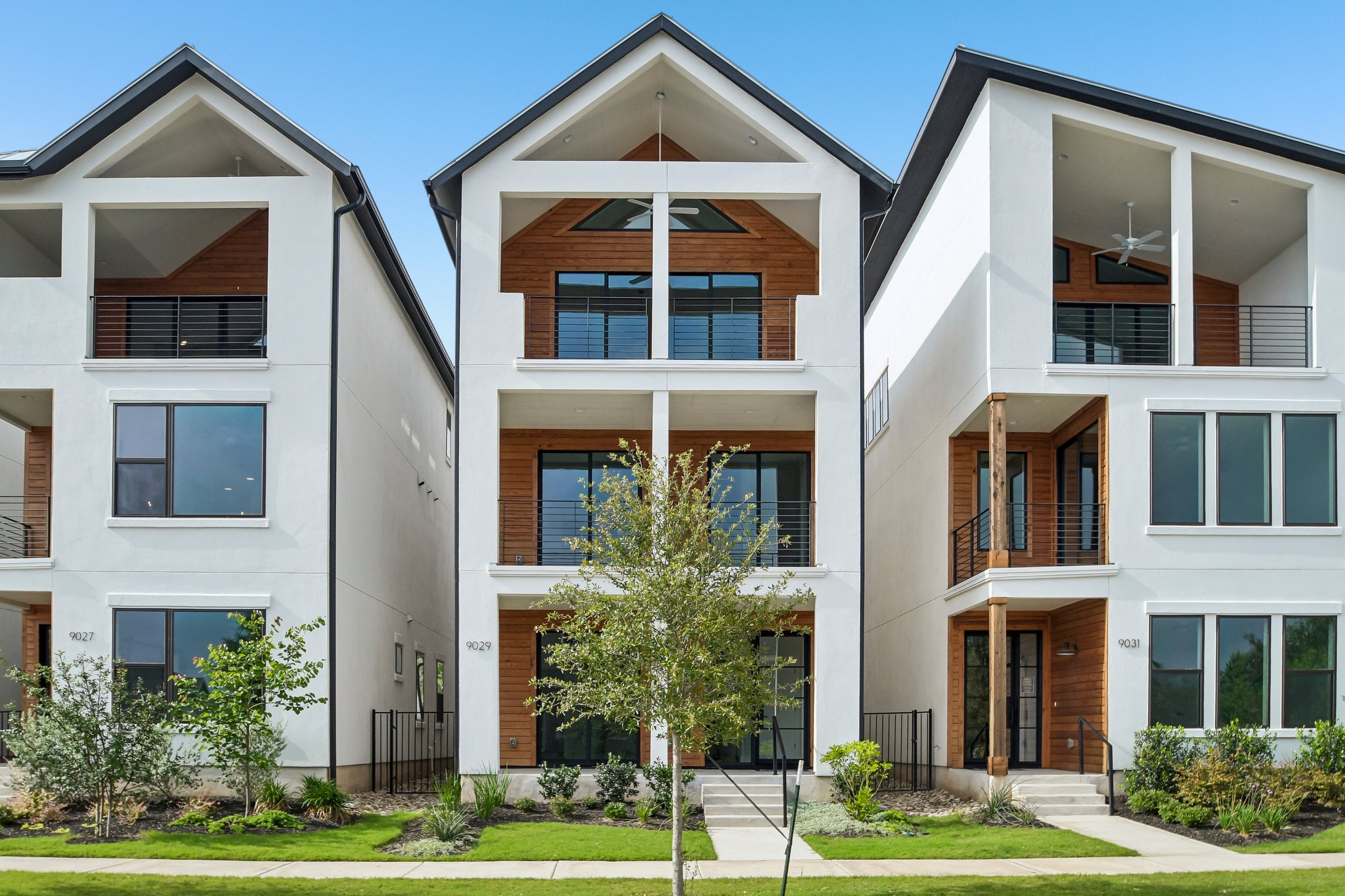 Bold modern architecture defines these striking townhomes, showcasing sleek lines and inviting balconies.