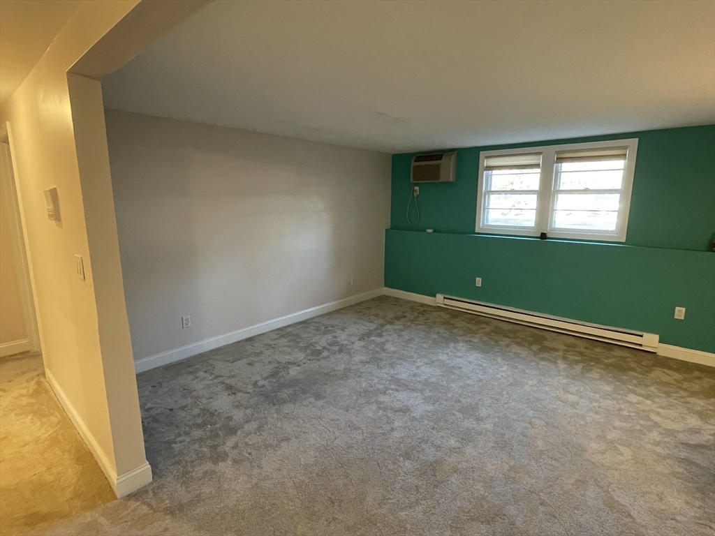 870 Haverhill Street, Unit 2B Rowley, MA 01969 - Photo 17 of 21 a view of an empty room with window and stairs