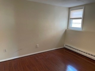 870 Haverhill Street, Unit 2B Rowley, MA 01969 - Photo 7 of 21 an empty room with wooden floor and windows