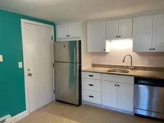a kitchen with appliances a sink and cabinets