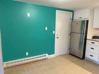 870 Haverhill Street, Unit 2B Rowley, MA 01969 - Photo 10 of 21 a view of kitchen with refrigerator and white cabinets