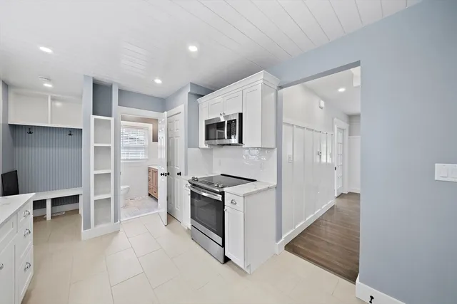 a kitchen with granite countertop cabinets and steel stainless steel appliances