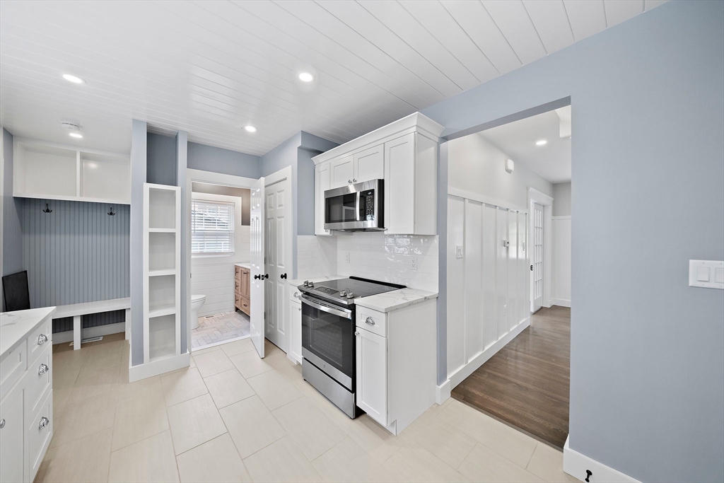 37 Wolcott Road, Unit 37 Brookline, MA 02467 - Photo 11 of 40 a kitchen with granite countertop cabinets and steel stainless steel appliances