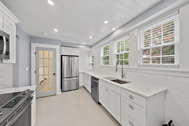 a kitchen with a stove a sink and a refrigerator