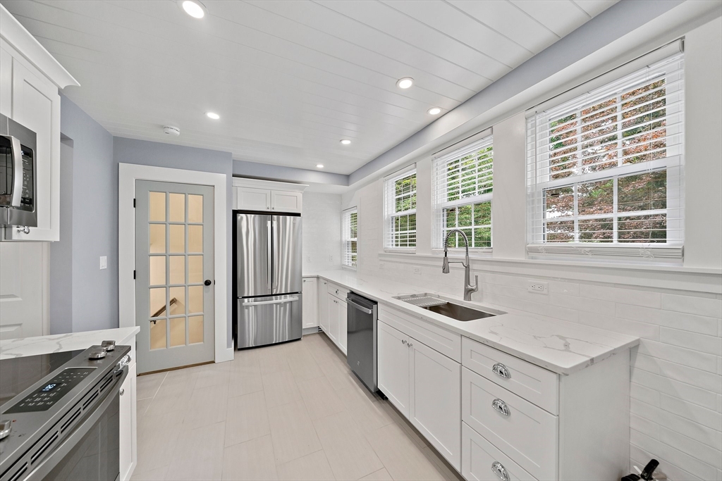37 Wolcott Road, Unit 37 Brookline, MA 02467 - Photo 13 of 40 a kitchen with a stove a sink and a refrigerator
