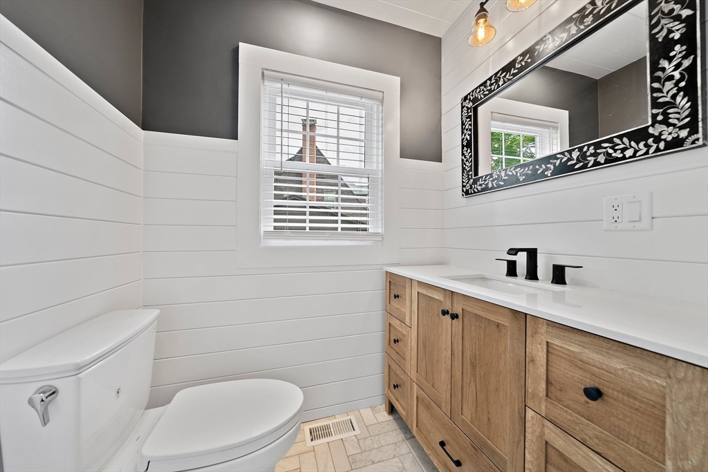 37 Wolcott Road, Unit 37 Brookline, MA 02467 - Photo 14 of 40 a bathroom with a sink a toilet and a window