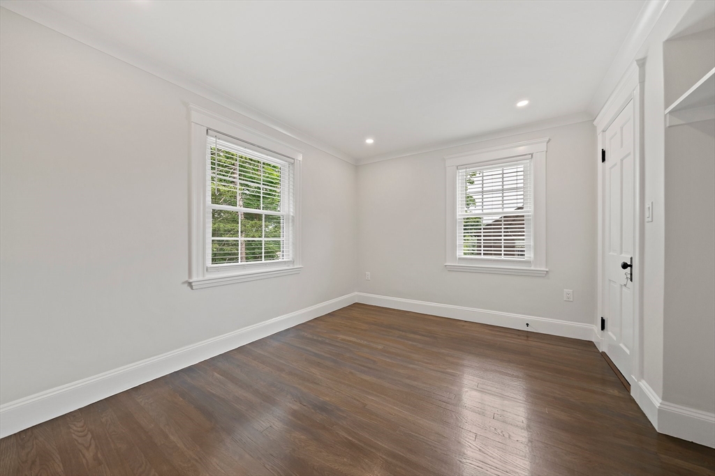 37 Wolcott Road, Unit 37 Brookline, MA 02467 - Photo 18 of 40 an empty room with wooden floor and windows